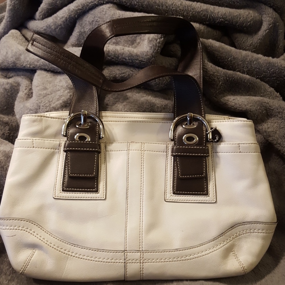 White and dark brown leather Coach purse.